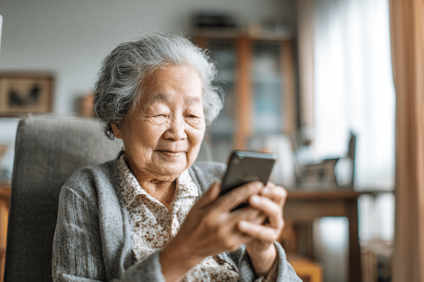 AI-generated illustrative image: A grandmother smiling while reading a message on her phone